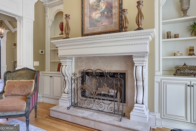 interior details featuring wood-type flooring and decorative columns