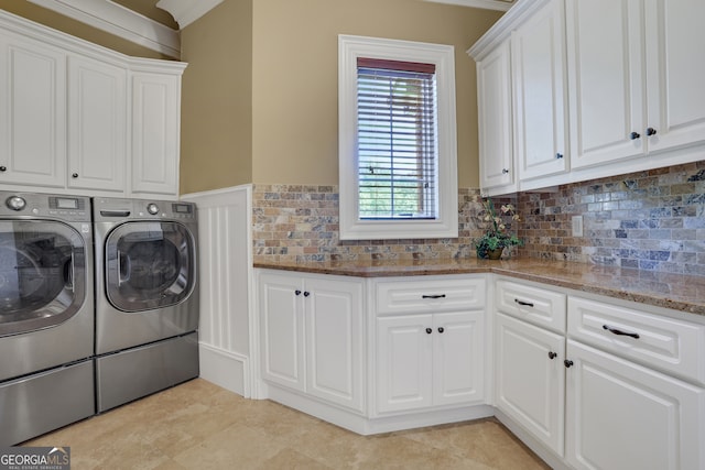 laundry area with ornamental molding, cabinets, and washing machine and dryer