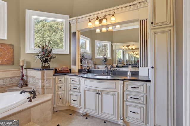 bathroom featuring tile patterned flooring, a relaxing tiled tub, and vanity