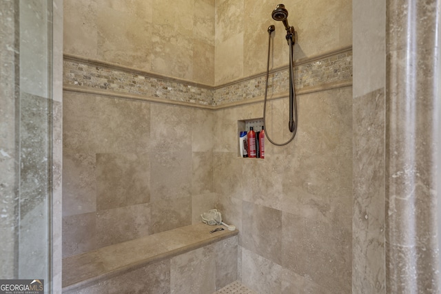 bathroom with a tile shower