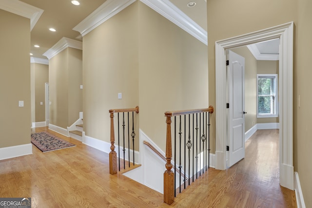 hall featuring light wood-type flooring and ornamental molding