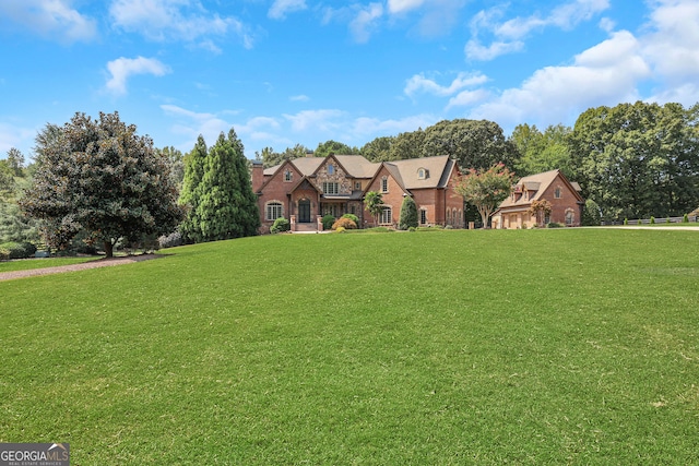 tudor home with a front lawn