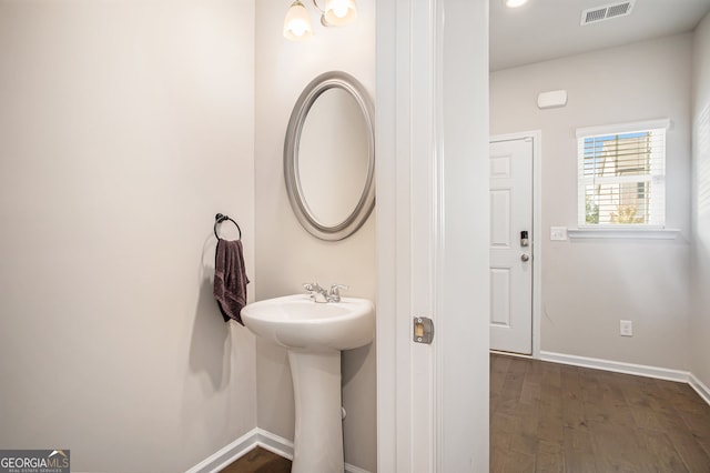 bathroom with wood-type flooring and sink