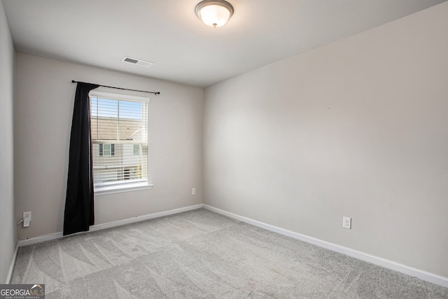 unfurnished room featuring light carpet