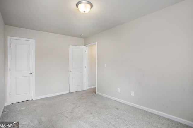 unfurnished bedroom with light colored carpet