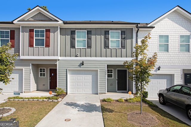 view of property with a front yard and a garage