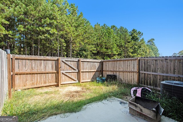 view of yard featuring cooling unit and a patio