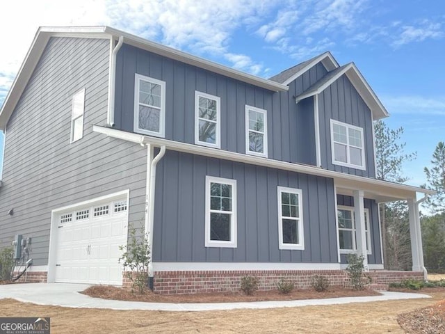 view of home's exterior with board and batten siding, an attached garage, and driveway