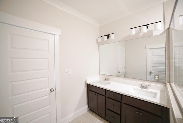 full bath with tile patterned floors, double vanity, a sink, and baseboards