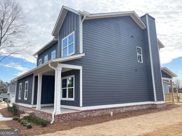 view of side of home with board and batten siding and a chimney