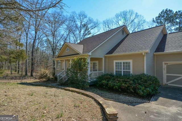 6865 Cowan Mill Rd, Winston, GA 30187 - view of home's exterior featuring an attached garage, a shingled roof, covered porch, and driveway