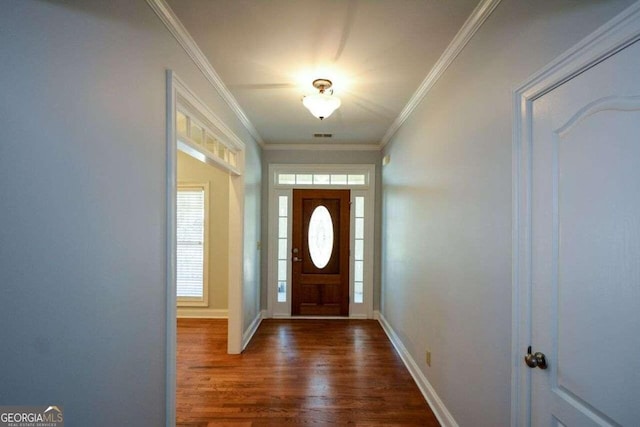 entrance foyer with dark wood-type flooring, a wealth of natural light, and crown molding