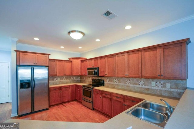 6865 Cowan Mill Rd, Winston, GA 30187 - kitchen with visible vents, a sink, light wood-type flooring, appliances with stainless steel finishes, and decorative backsplash
