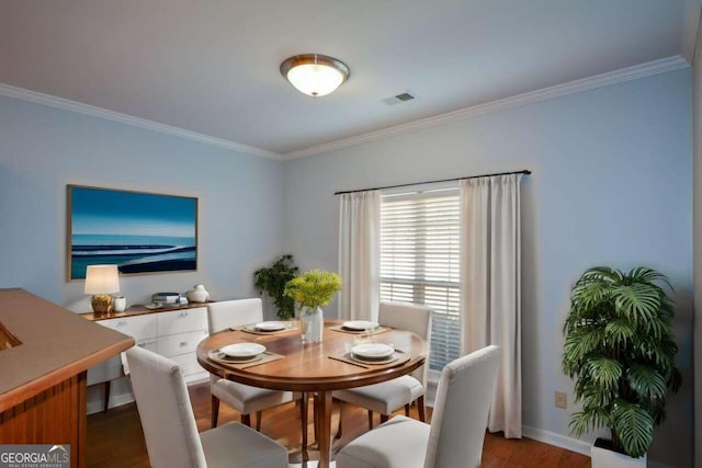 dining area featuring crown molding and wood-type flooring