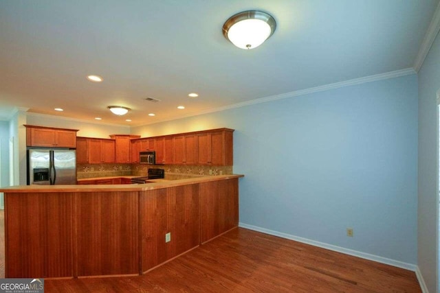 6865 Cowan Mill Rd, Winston, GA 30187 - kitchen with dark wood finished floors, brown cabinetry, a peninsula, appliances with stainless steel finishes, and backsplash