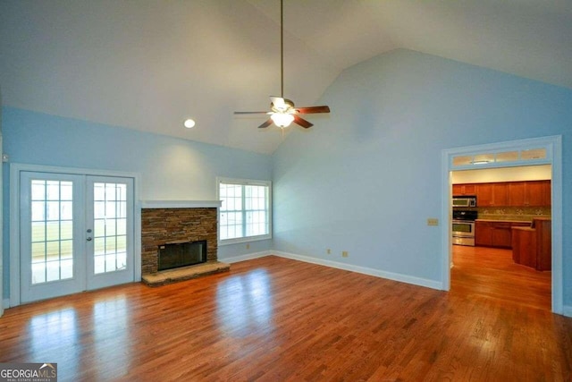 6865 Cowan Mill Rd, Winston, GA 30187 - unfurnished living room featuring baseboards, french doors, a ceiling fan, high vaulted ceiling, and wood finished floors