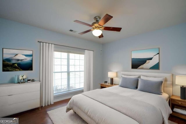 bedroom with ceiling fan and dark hardwood / wood-style floors