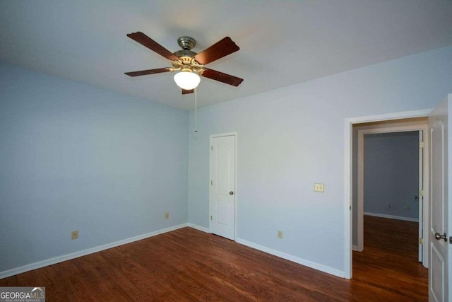 spare room with ceiling fan and dark hardwood / wood-style flooring