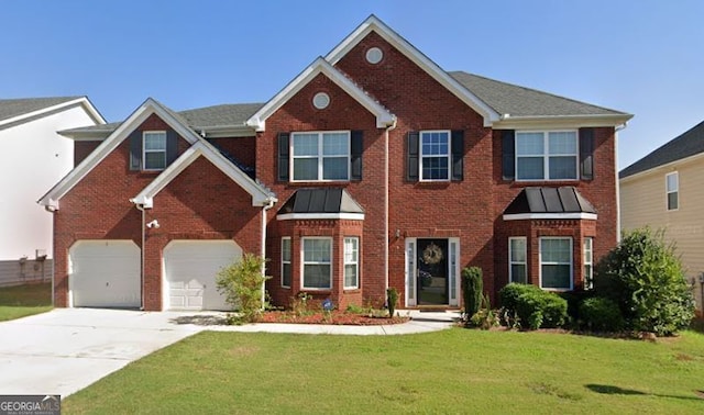 view of front of house with a front yard and a garage