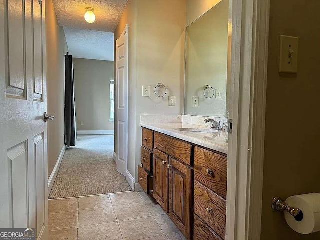 bathroom featuring tile patterned floors, a textured ceiling, and vanity