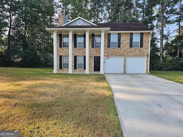 neoclassical home featuring a garage and a front lawn