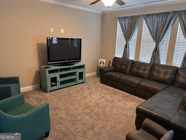 carpeted living room featuring ceiling fan and ornamental molding