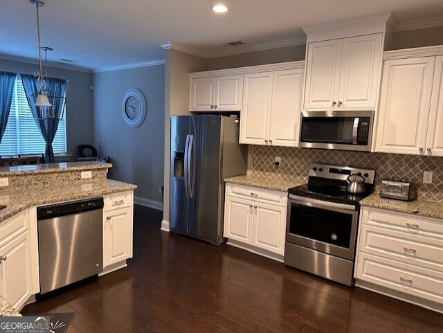 kitchen featuring dark hardwood / wood-style floors, stainless steel appliances, white cabinets, and hanging light fixtures