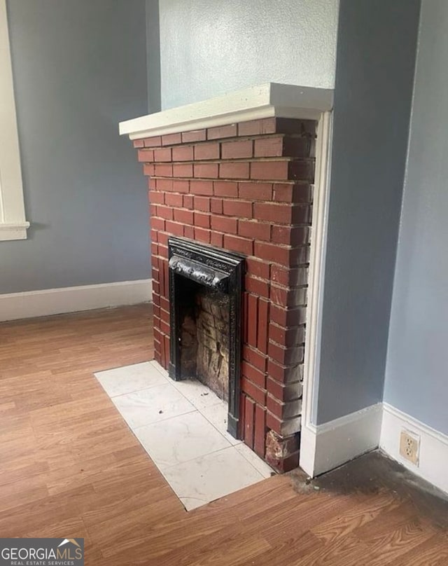 room details with hardwood / wood-style floors and a fireplace