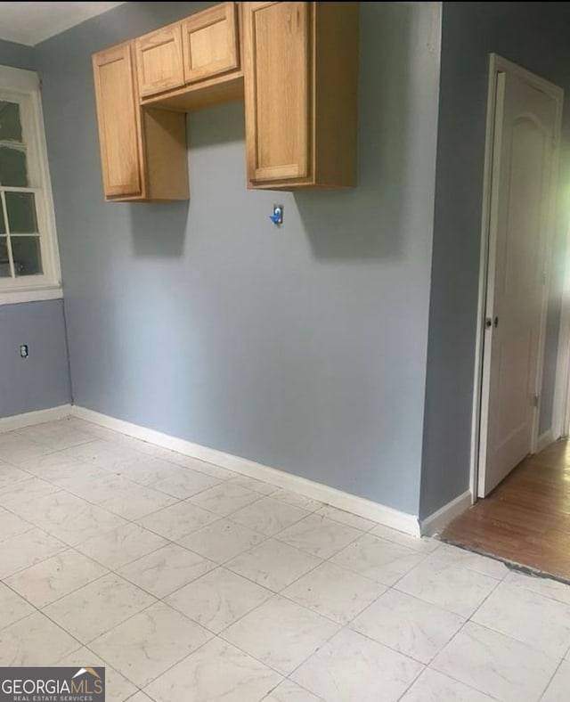 laundry area with light wood-type flooring