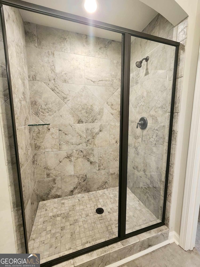 bathroom featuring a shower with door