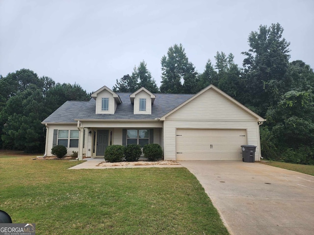 new england style home featuring a garage, covered porch, and a front yard