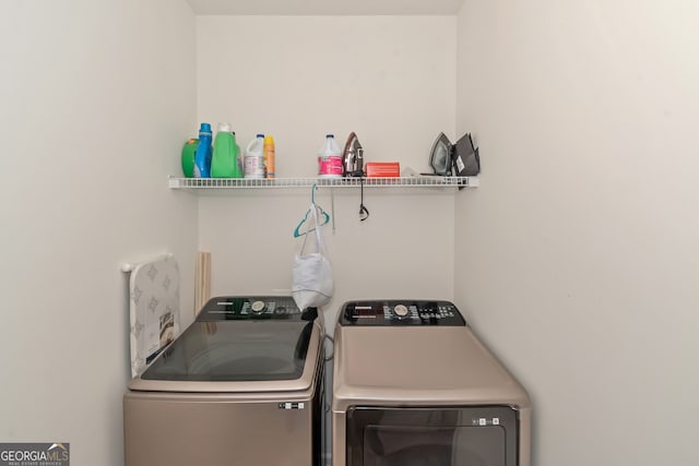 washroom with washing machine and clothes dryer