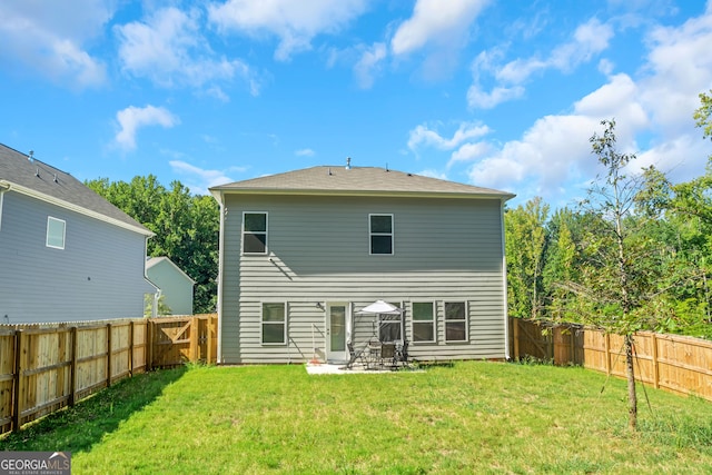 rear view of property with a lawn