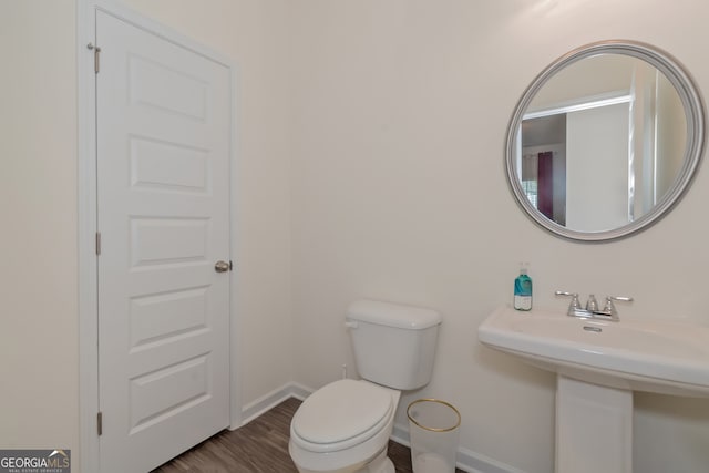 bathroom with wood-type flooring and toilet