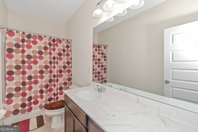 bathroom featuring vanity, toilet, and curtained shower