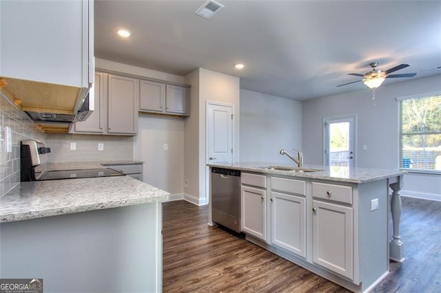 kitchen with black stove, dishwasher, ceiling fan, a center island with sink, and sink