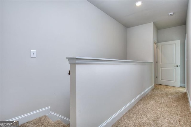 corridor with light colored carpet