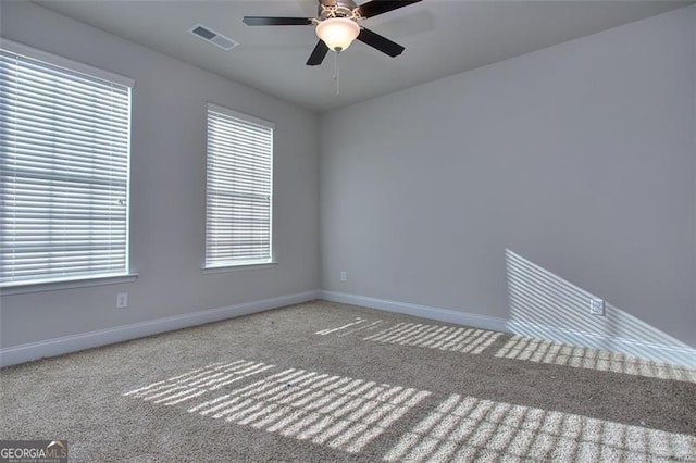 carpeted spare room with ceiling fan