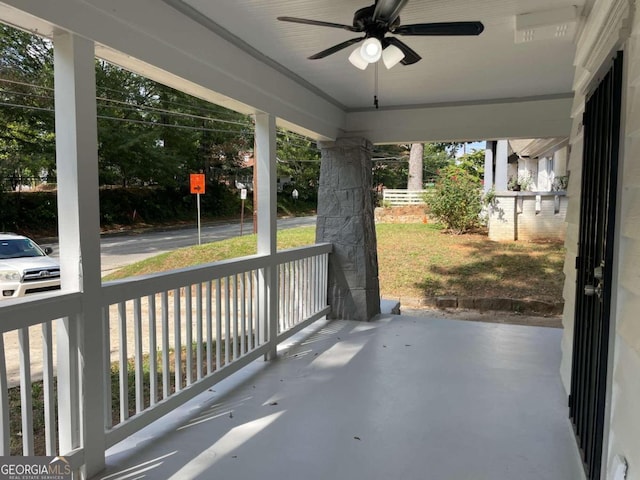 unfurnished sunroom with ceiling fan