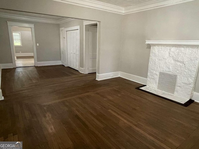 unfurnished living room with a fireplace, dark hardwood / wood-style flooring, and ornamental molding