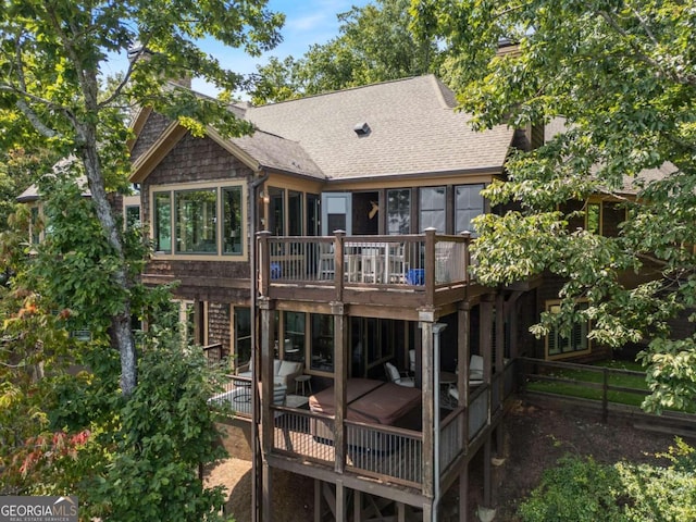 rear view of property featuring a deck