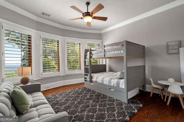 bedroom with ceiling fan, crown molding, and dark hardwood / wood-style flooring