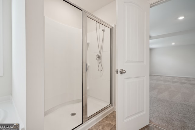 bathroom with a shower with shower door