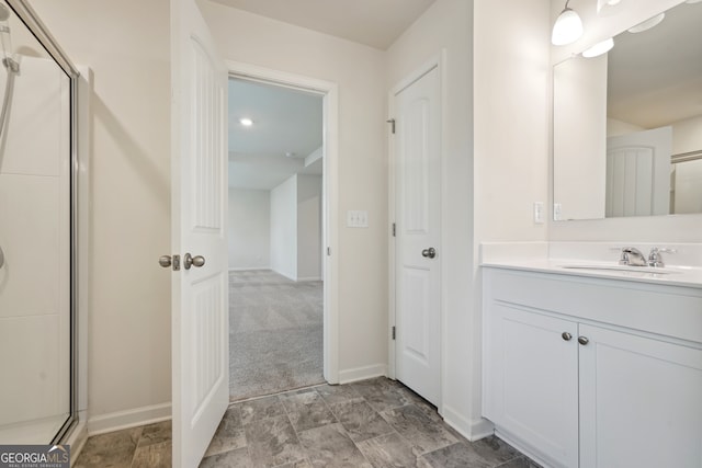 bathroom featuring vanity and a shower with door