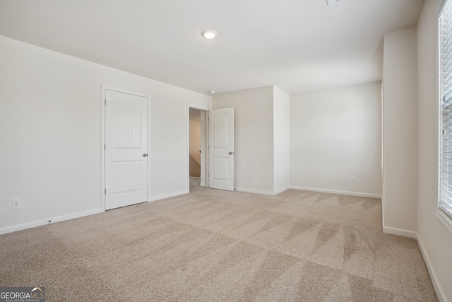 spare room with light carpet