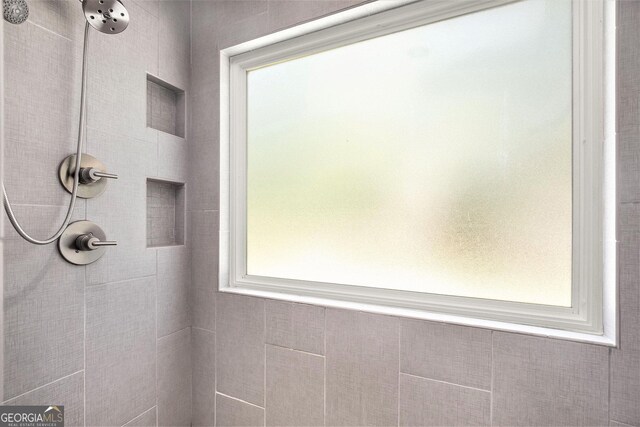 bathroom with a tile shower