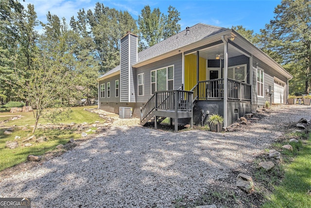 exterior space with a garage and central AC