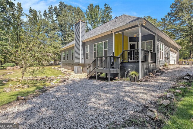 103 Royal Way, Mcdonough, GA 30252 - view of front of home with a shingled roof, a porch, cooling unit, a chimney, and an attached garage
