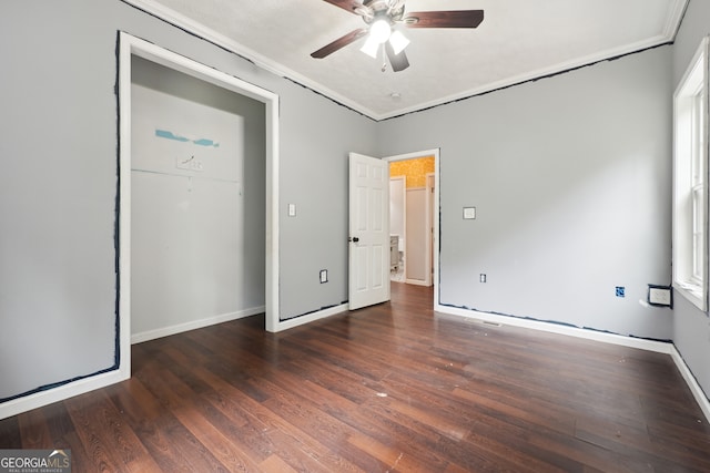 unfurnished bedroom with crown molding, dark hardwood / wood-style flooring, and ceiling fan