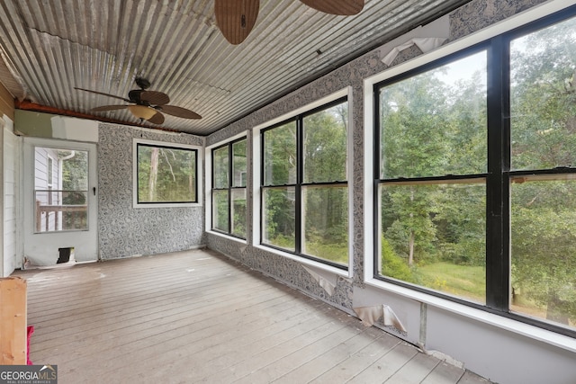 unfurnished sunroom featuring wood ceiling and ceiling fan